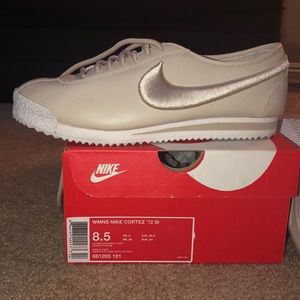 Tan and white Nike women’s Cortez